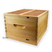 A wooden double nuc box kit used for beekeeping, with a handle on the side and a honeycomb pattern on the top.