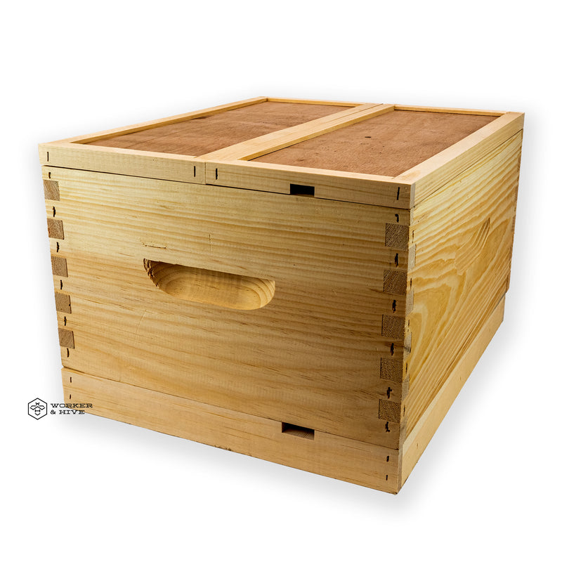 A wooden double nuc box kit used for beekeeping, with a handle on the side and a honeycomb pattern on the top.