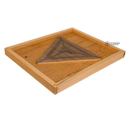 A wooden beehive escape board with a triangular mesh gate laid on top.
